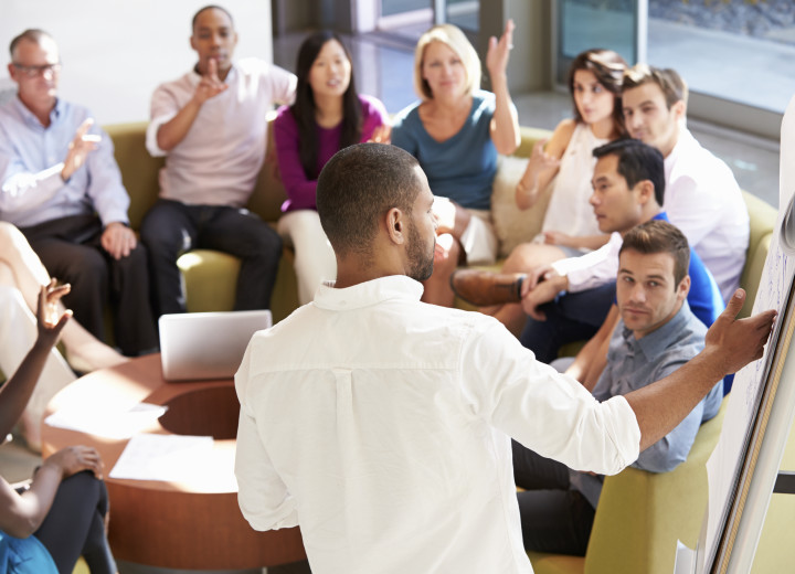 Businessman Making Presentation To Office Colleagues